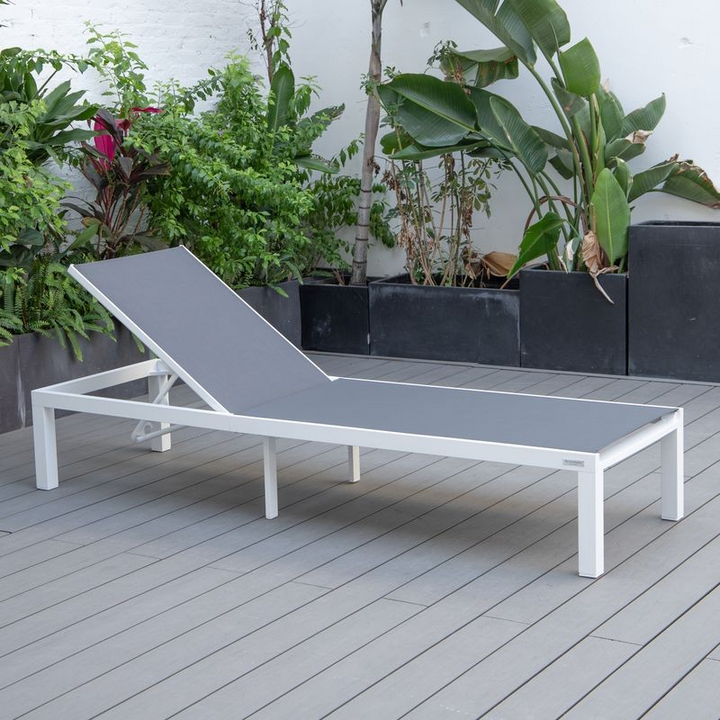 LeisureMod Marlin Patio Chaise Lounge Chair with White Aluminum Frame Dark Grey on Deck.