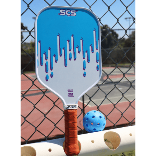 Pickleball paddle with blue design and USA branding on a court background.