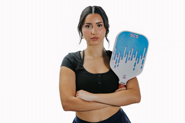 Woman holding a paddle with 'SCS' branding on a white background.