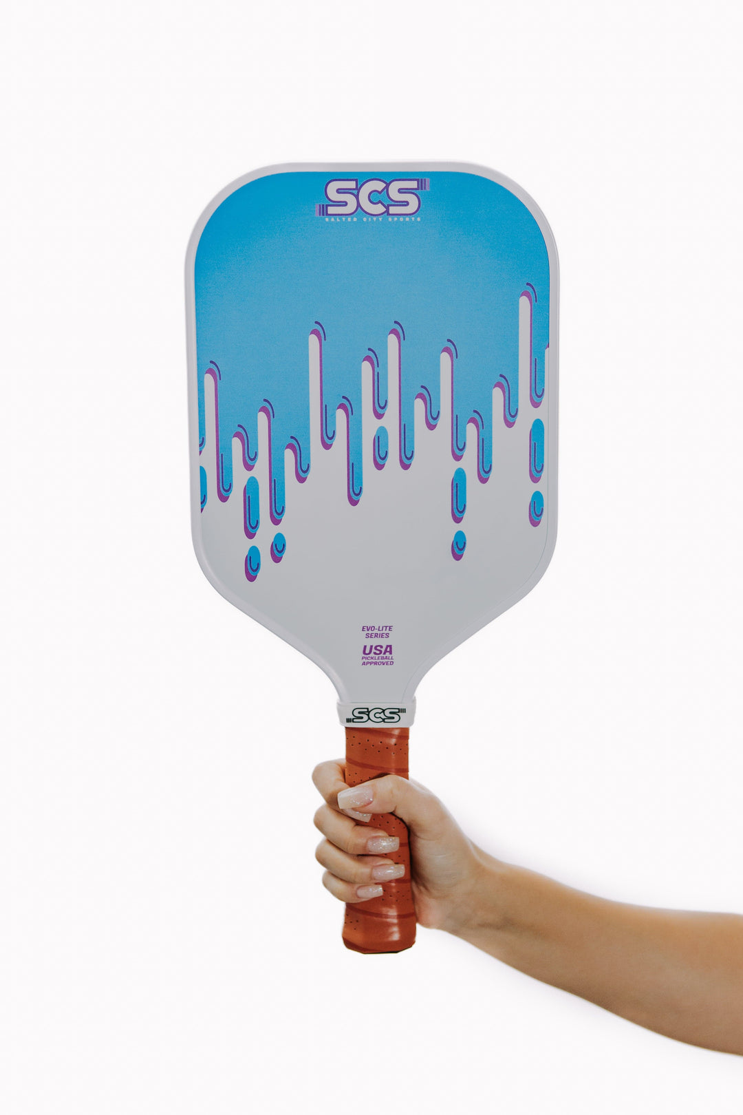 Blue and white pickleball paddle with 'SCS' branding held by a hand on a white background.
