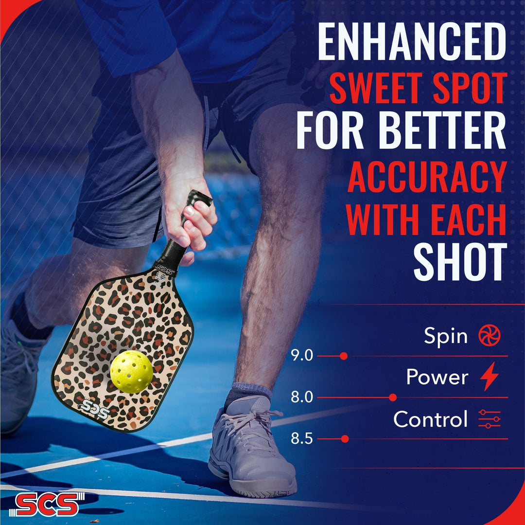 Person holding a pickleball paddle with a leopard print pattern on a blue court, promoting better accuracy with each shot.