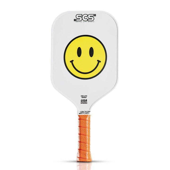 Pickleball paddle with smiley face design and orange handle on a white background.