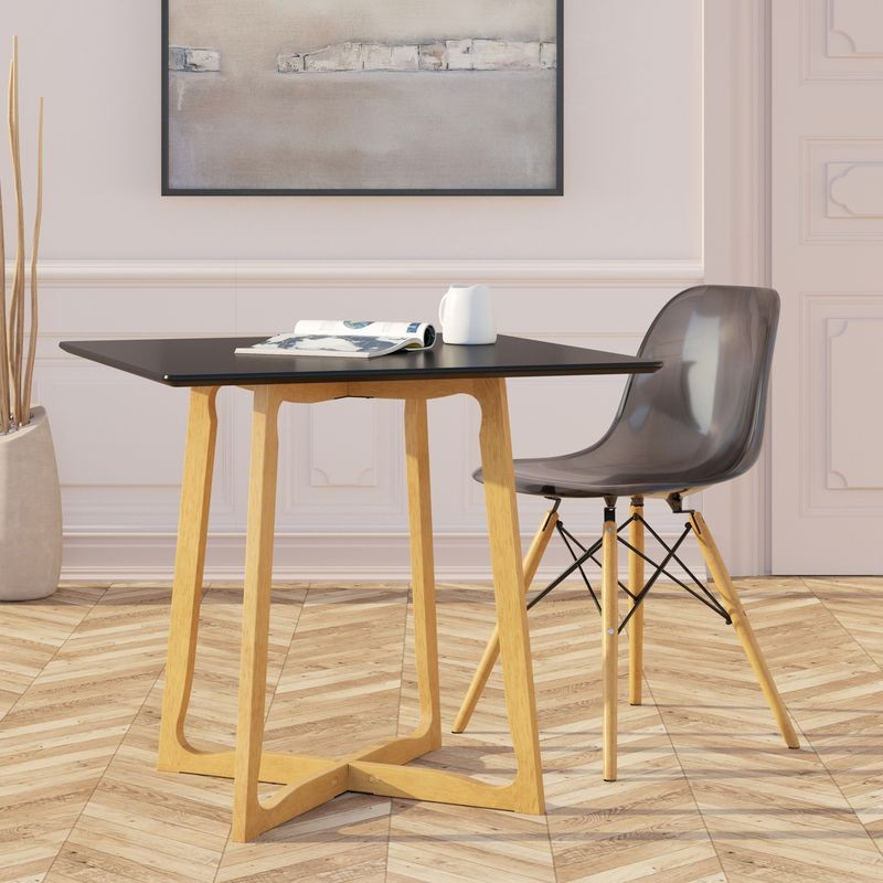 LeisureMod Dover Plastic Molded Dining Side Chair Transparent Black at Table.