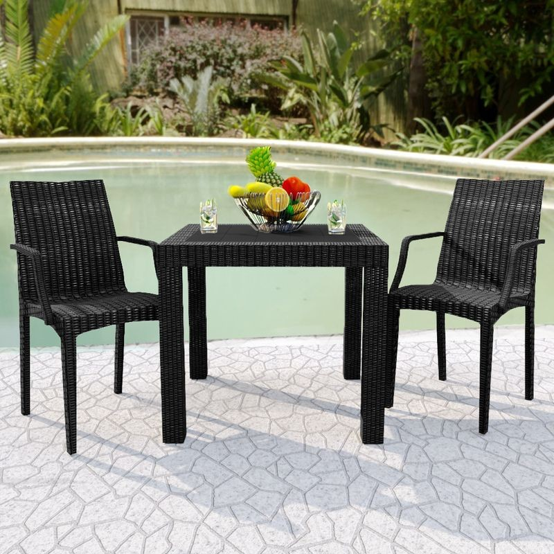 LeisureMod Weave Mace Indoor/Outdoor Chair (With Arms) Black at Table.