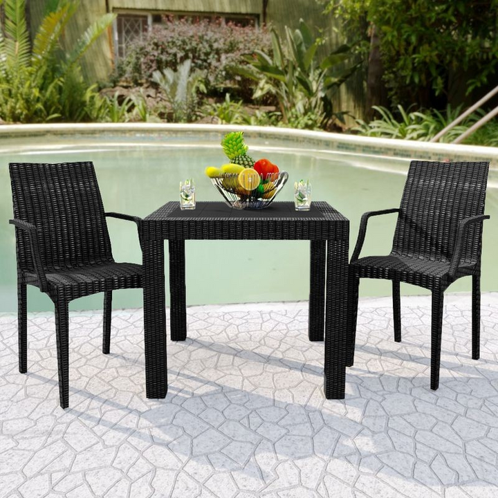 LeisureMod Weave Mace Indoor/Outdoor Chair (With Arms) Black at Table.