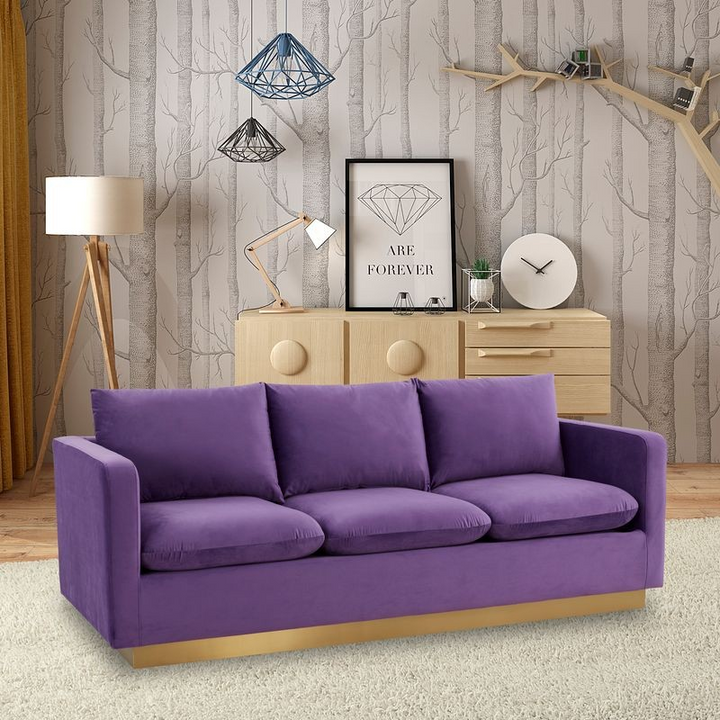LeisureMod Nervo Modern Mid-Century Upholstered Velvet Sofa with Gold Frame Purple with Background.