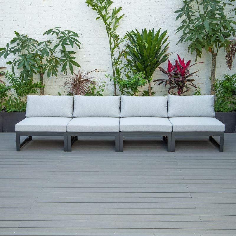 LeisureMod Chelsea 4-Piece Middle Patio Chairs Black Aluminum with Cushions Light Grey in a Row.