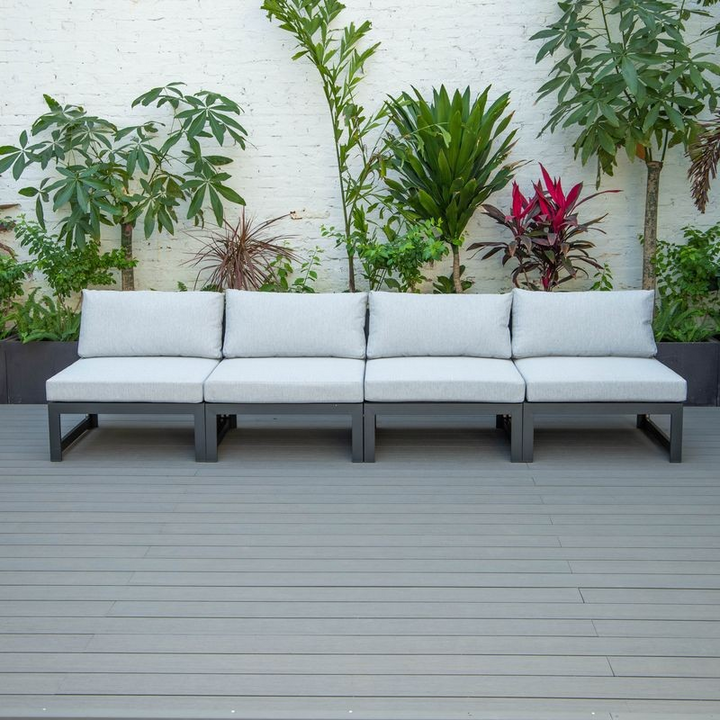 LeisureMod Chelsea 4-Piece Middle Patio Chairs Black Aluminum with Cushions Light Grey in a Row.