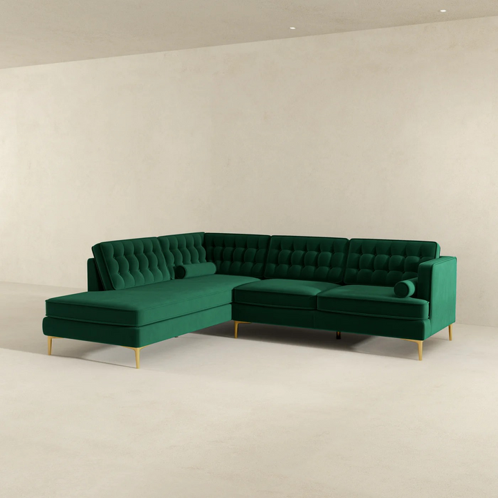 Green sectional sofa on a beige background.