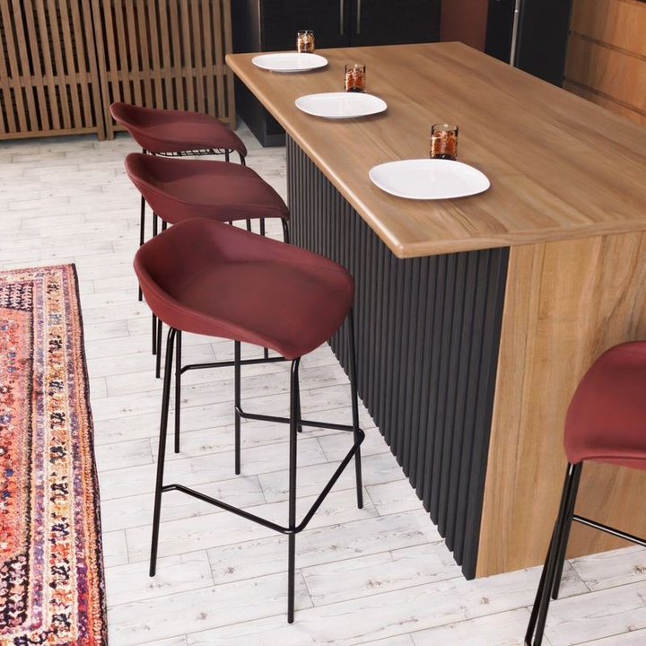 LeisureMod Servos Modern Barstool with Upholstered Faux Leather Seat and Powder Coated Iron Frame in Bordeaux at Bar.