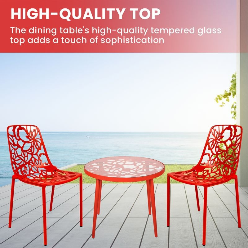 Red outdoor dining set with high-quality tempered glass table on a deck by the sea.