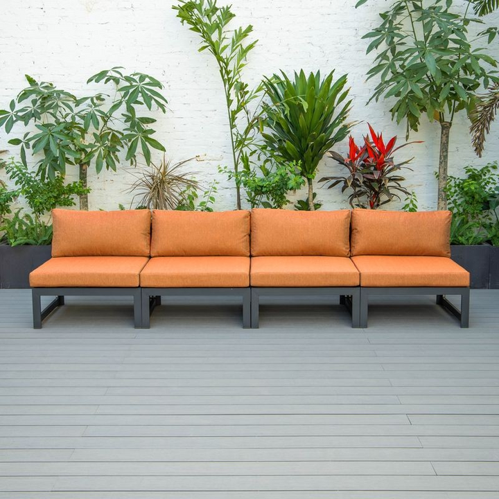 LeisureMod Chelsea 4-Piece Middle Patio Chairs Black Aluminum with Cushions Orange in a Row.