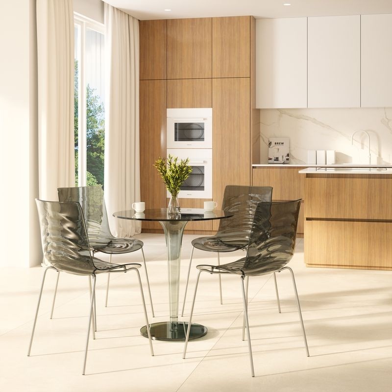 Modern kitchen with wooden cabinets, glass dining table, and chairs.