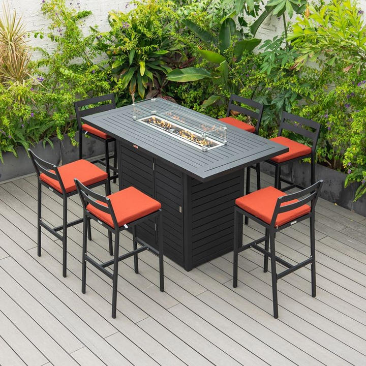 LeisureMod Chelsea Collection Modern Aluminum Outdoor Bar Chair in Black with Cherry Cushions at the Table.