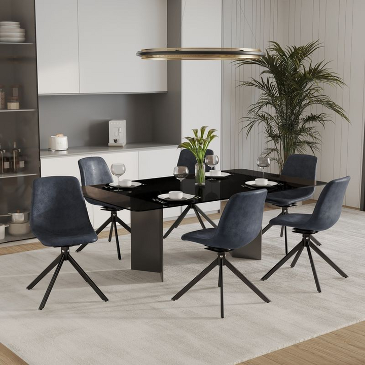 LeisureMod Markley Modern Leather Swivel Dining Chair With Metal Legs in Black at Table.