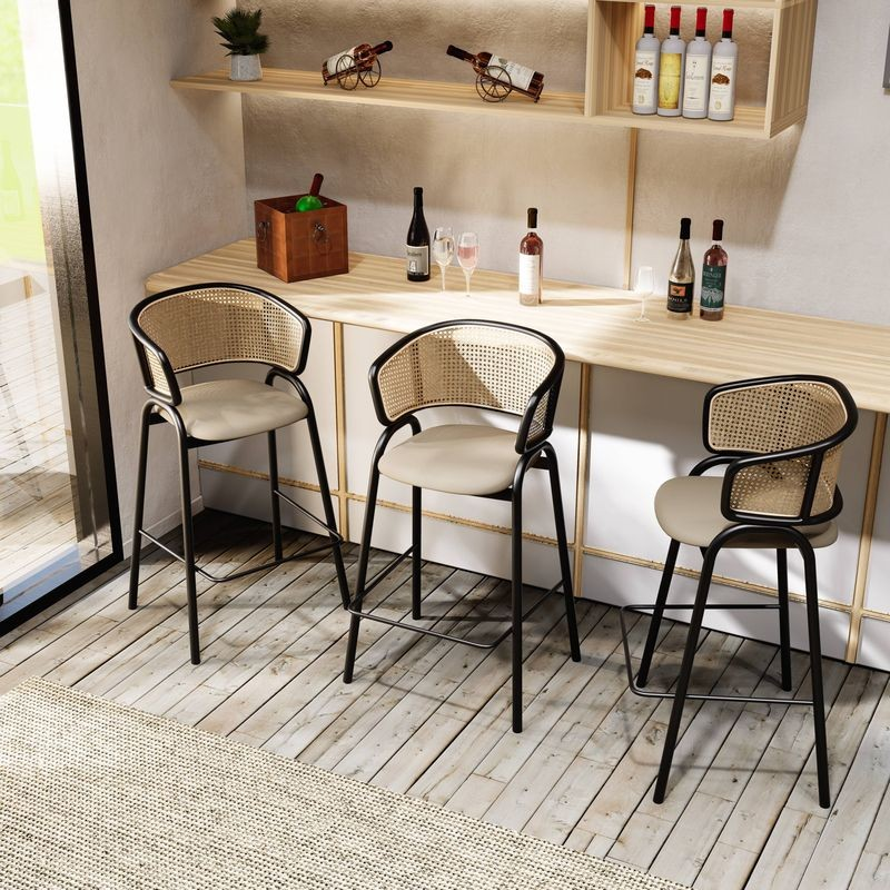 LeisureMod Ervilla Wicker Bar Stool with Fabric Seat and Black Steel Frame in Taupe at Bar.