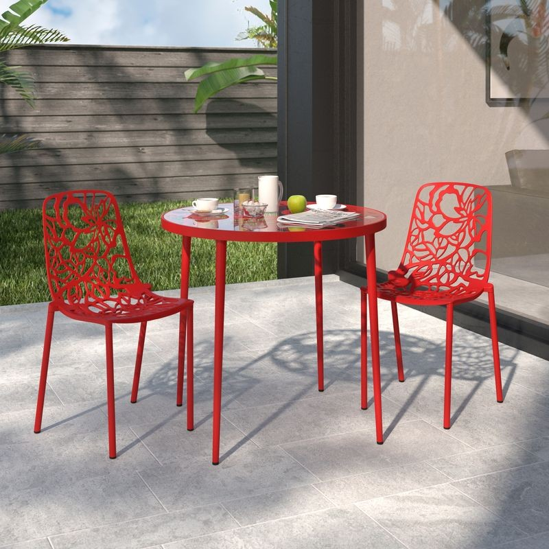 Red outdoor table and chairs set on a patio with a neutral background.