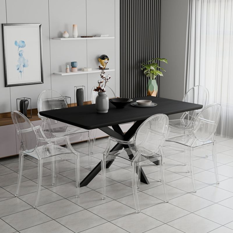 Dining area with a black table and transparent chairs in a modern kitchen.