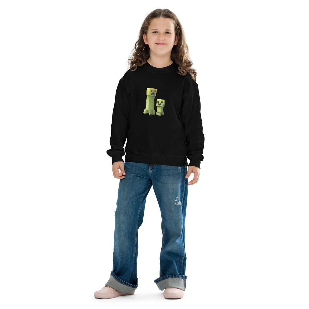 Child wearing a black sweatshirt with a green character design on a white background.