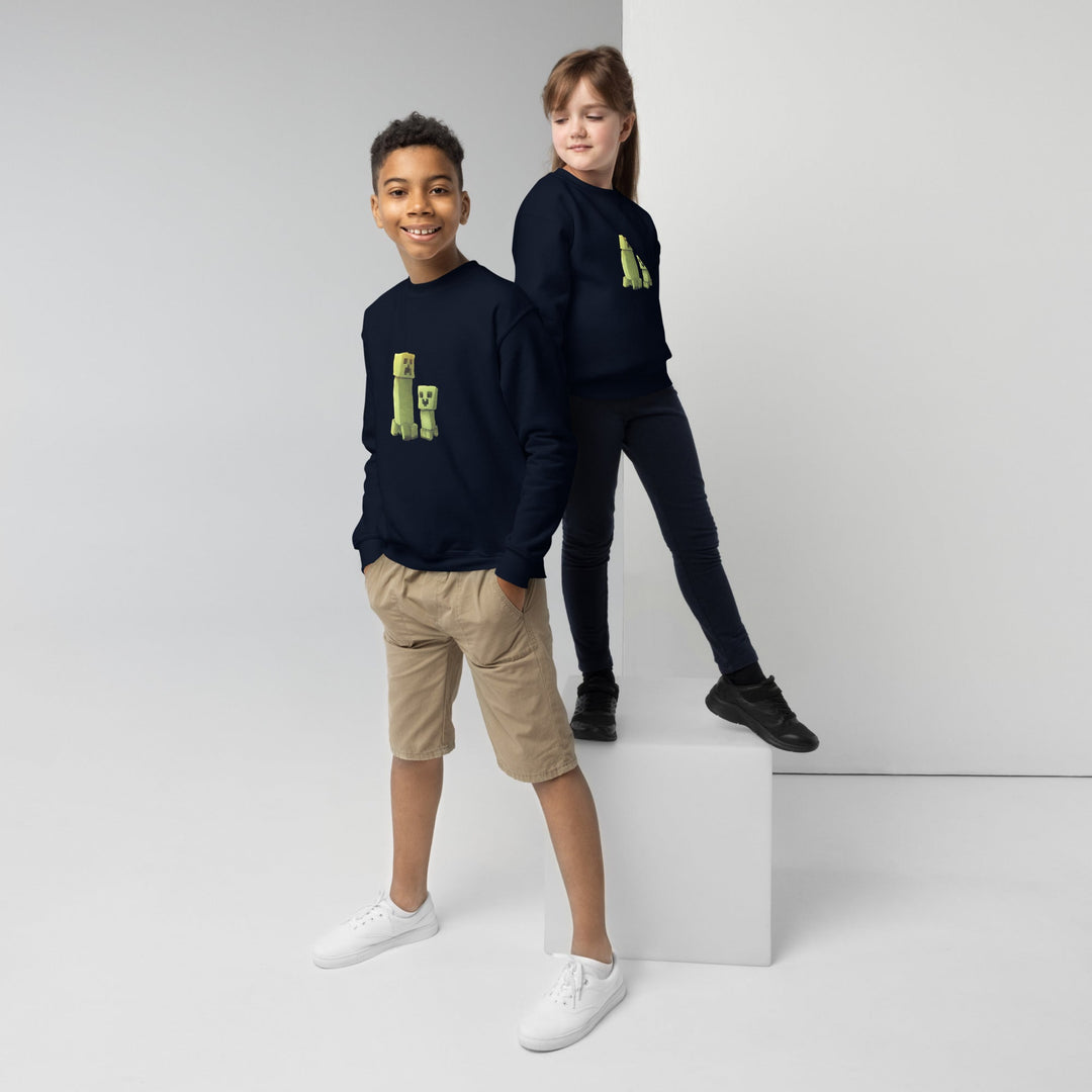 Two children wearing navy blue sweatshirts with green graphics on a white background.