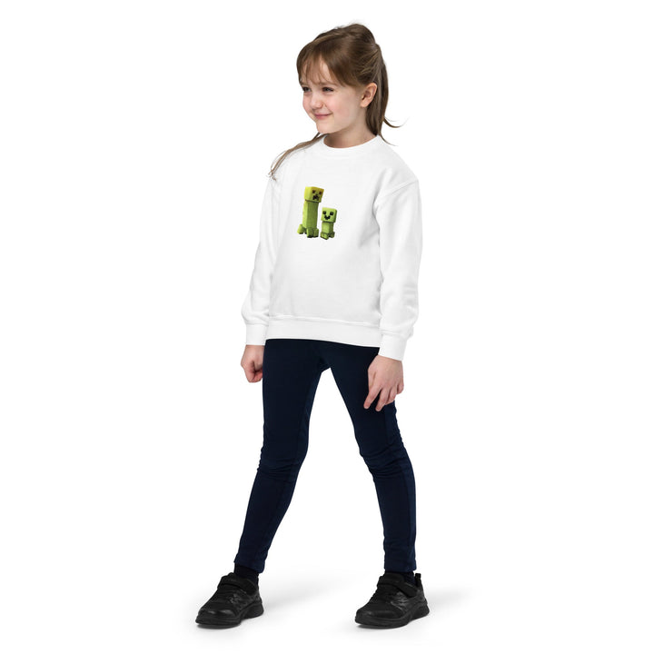 Young girl wearing a white sweatshirt with a green graphic design on a white background.