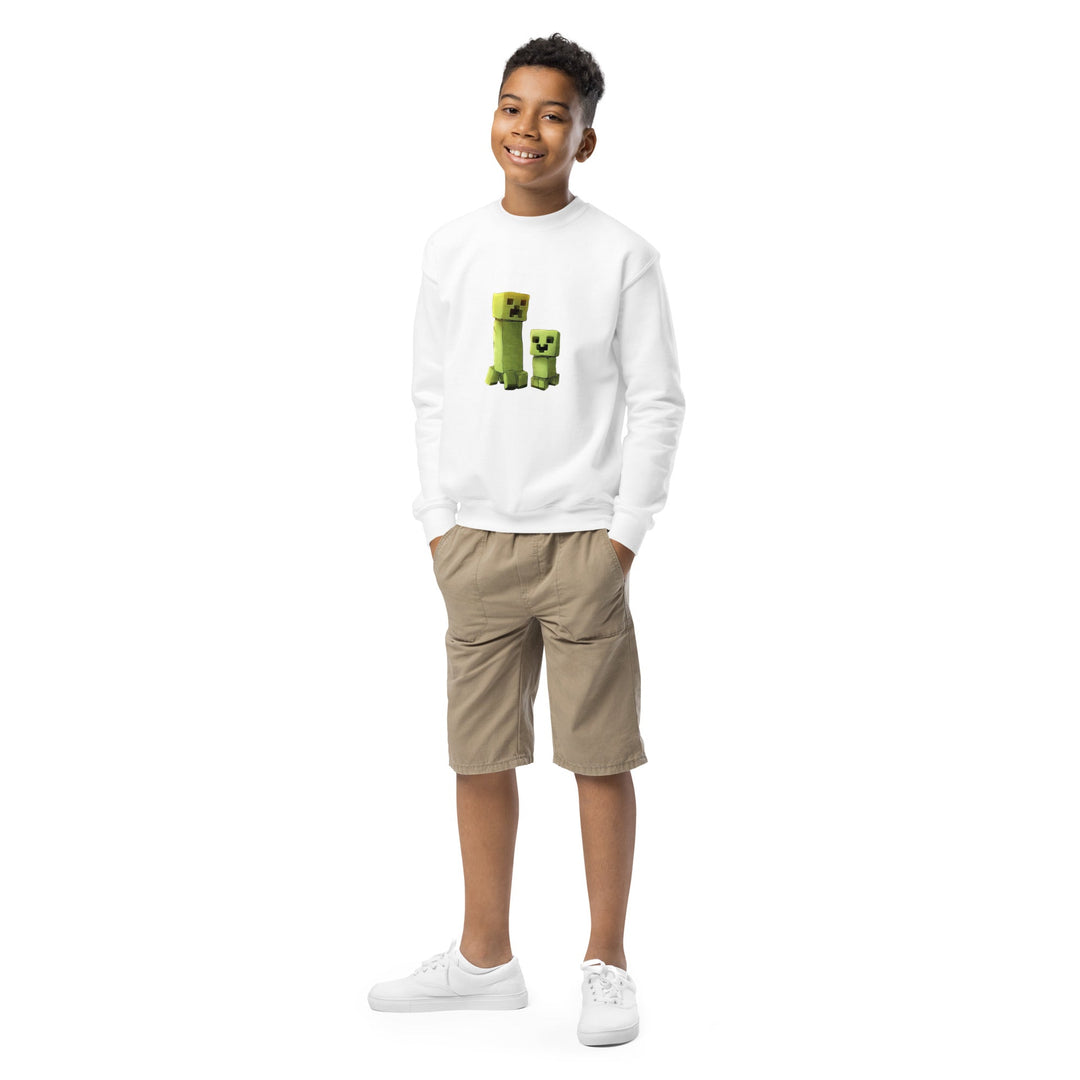 Child wearing a white sweatshirt with green graphics and beige shorts on a white background.
