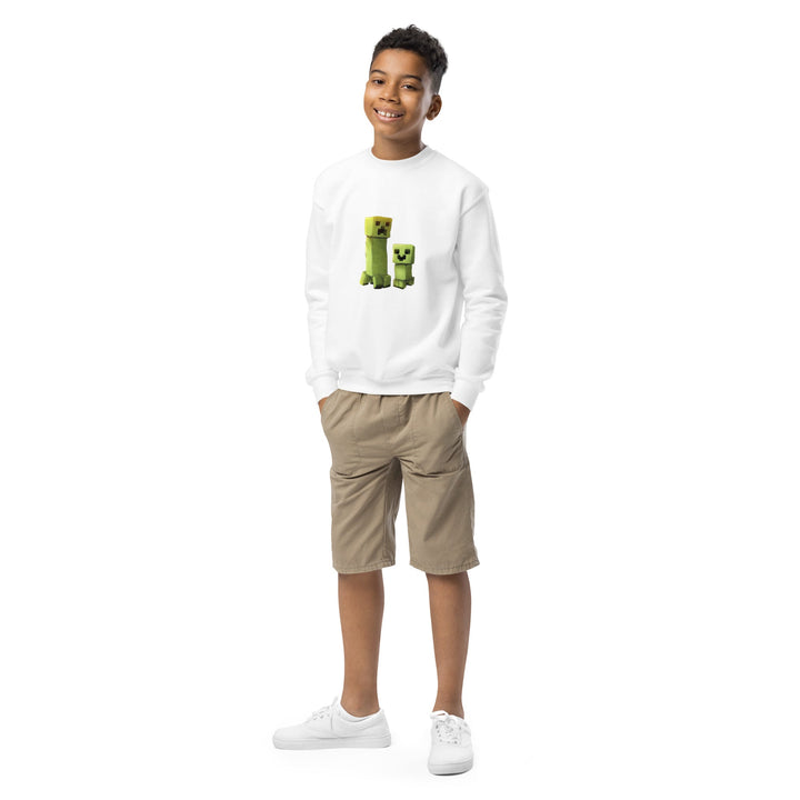 Child wearing a white sweatshirt with green graphics and beige shorts on a white background.