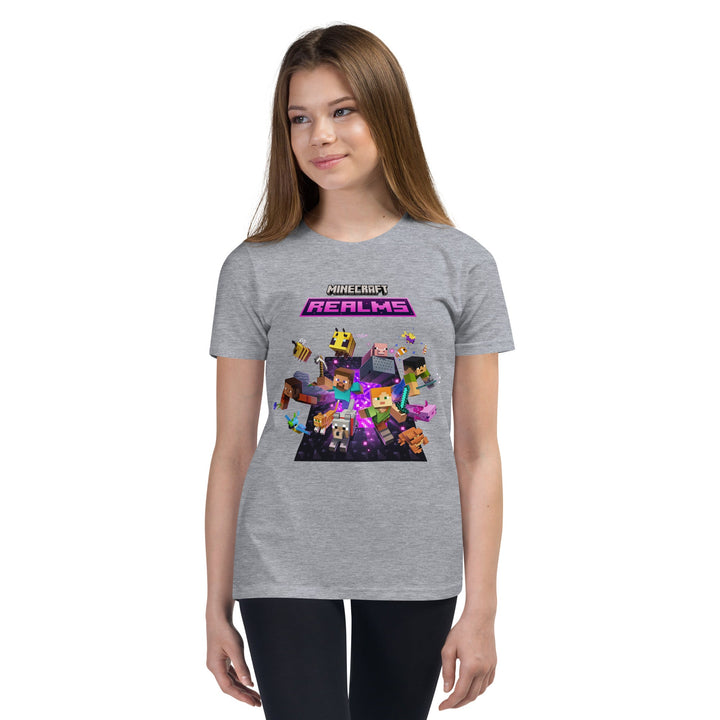 Person wearing a gray t-shirt with Minecraft Realms graphics on a white background.