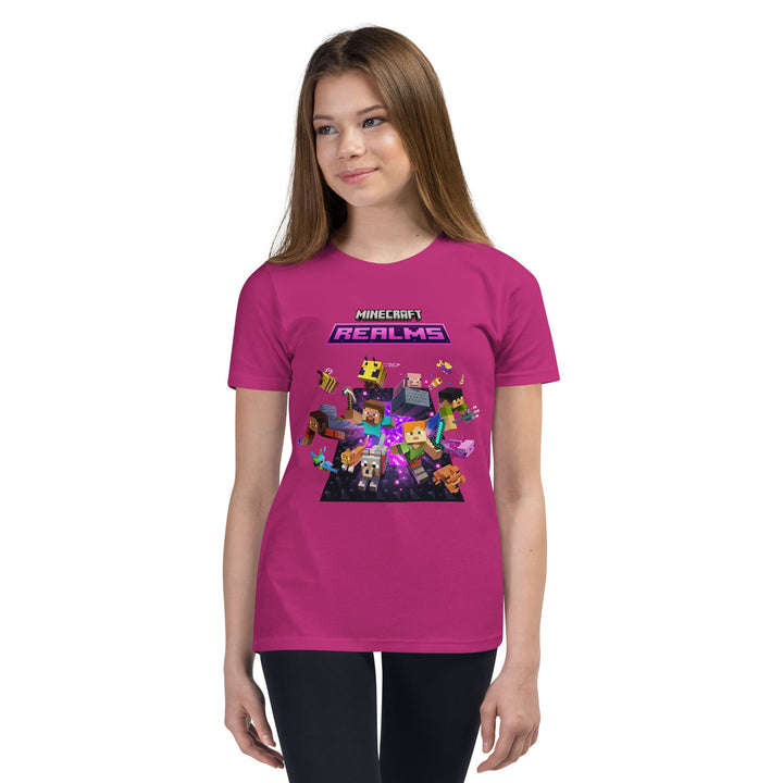 Person wearing a pink t-shirt with Minecraft Realms graphics on a white background.