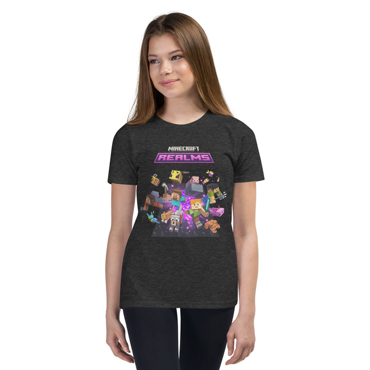 Person wearing a dark gray t-shirt with Minecraft Realms graphics on a white background.