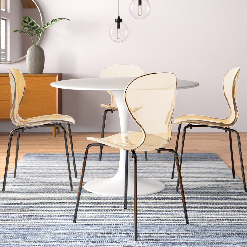 LeisureMod Modern Oyster Transparent Side Chair in Black Base set of 2 Amber at Table.